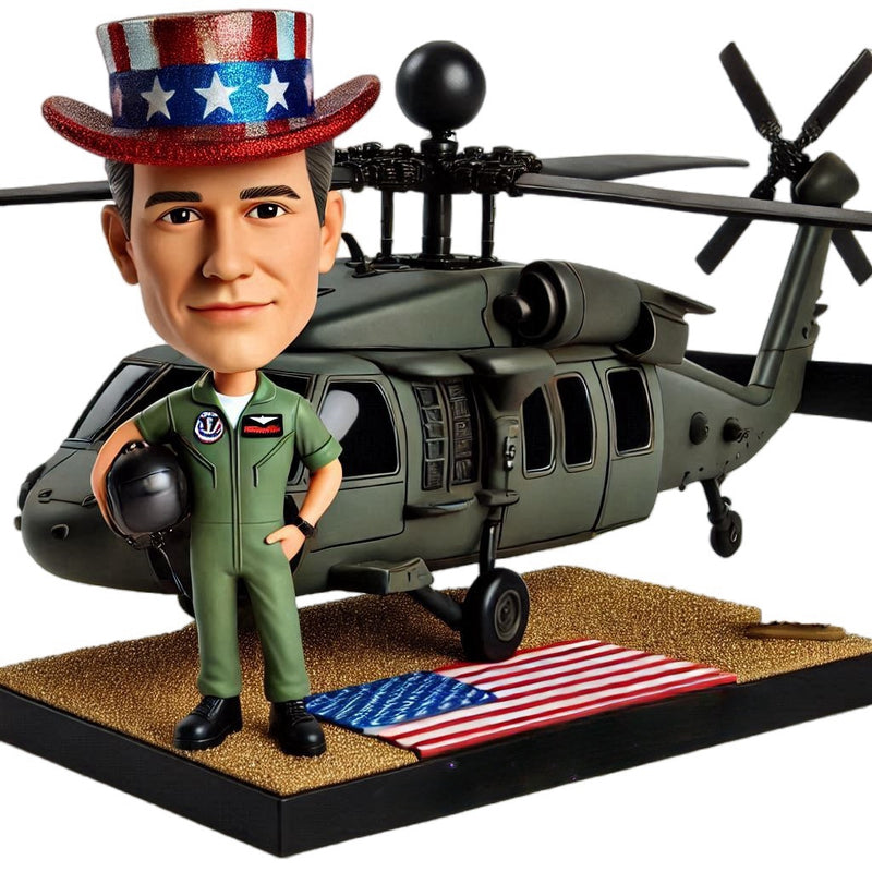 Custom bobblehead doll of pilot carrying Black Hawk model airplane, engraved with words